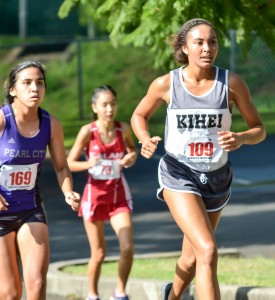 Kihei Charter's Maya Reynolds climbs a hill through the first mile Saturday at Seabury Hall. Photo by Rodney S. Yap.