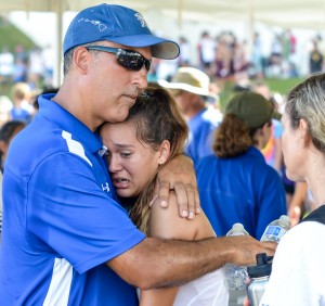 Seabury Hall head coach Bobby Grossman gives Ava Shipman a big hug following her fourth-place finish Saturday at the state cross country championships. Photo by Rodney S. Yap.