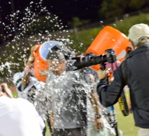 The Molokai players get head coach Mike Kahale with a Gatorade bath on the sidelines Saturday. Photo by Rodney S. Yap.