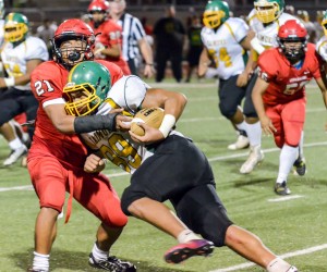 Lahainaluna's Donovan Defang tackles Kaimuki's Billie Masima one-on-one during second-half action Saturday. Photo by Rodney S. Yap.