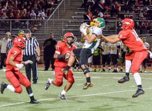 Lahainaluna's secondary converges on Kaimuki's receiver after he catches a pass in the middle of the field. Photo by Rodney S. Yap.