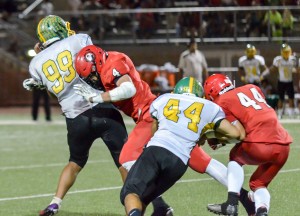 Lahainaluna's Nau Filiai lowers the boom on Kaimuki's Billie Masima as he throws a pass to the wide side of the field. Photo by Rodney S. Yap.