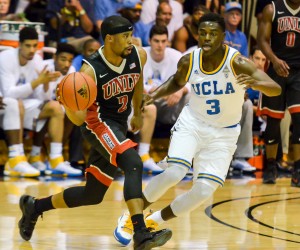 UNLV's Jerome Seagears completes a bounce pass as he hurries to bring the ball up-court against UCLA defender Aaron Holiday. Photo by Rodney S. Yap.