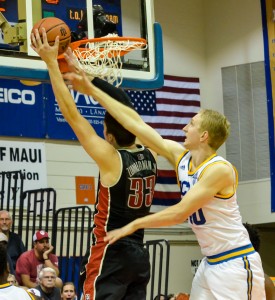 UCLA's Thomas Welsh blocks a would-be basket by UNLV's Stephen Zimmerman during second-half action Monday at Lahaina Civic Center. Photo by Rodney S. Yap.