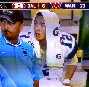 Bladwin quarterback Chayce Akaka takes a break on the sidelines late in the game Friday against Waianae. Photo from OC16 broadcast.