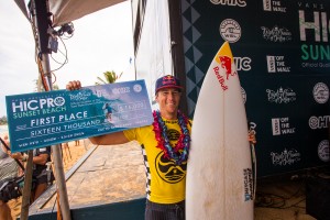 Ian Walsh from Maui smiles on the podium, taking first place at the HIC Pro ten years after his first win at the same event. Photo courtesy of World Surf League (WSL).