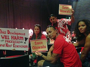 Lisa Marquis (from left), Peter deAquino, Davin Balagso and Kiana Carroll, all from Lahaina, came prepared both with signs and testimony against the Olowala Final Environmental Impact Statement. Debra Lordan photo.