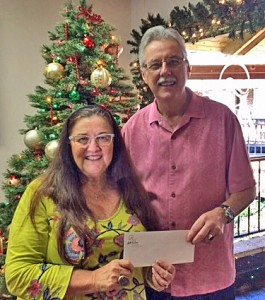 Wailea Community Association’s General Manager, Bud Pikrone, presented checks totaling around $6,600 to Marlene Rice, Development Director for the Maui Food Bank.  Courtesy photo.