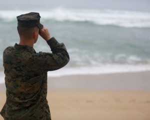 A Marine Officer attached to Marine Heavy Helicopter Squadron 463 uses binoculars to search for debris of a helicopter mishap in Haleiwa Beach Park, Jan. 15, 2016. The mission of Marine Corps Base Hawaii is to provide facilities, programs and services in direct support of units, individuals and families in order to enhance and sustain combat readiness for all operating forces and tenant organizations aboard MCB Hawaii. (U.S. Marine Corps photo by Cpl. Ricky S. Gomez/ Released)