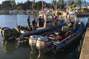 Members of the Navy’s Mobile Diving Salvage Unit-1, Joint Base Pearl Harbor, Hickam, Hawaii, make preparations at Haleiwa, Hawaii, to continue operations during the fourth day of the search the 12 missing Marines on Jan. 19, 2016. The operation is part of the joint rescue effort following the mishap involving two Marine Corps CH-53E Super Stallion helicopters the night of Jan. 14, 2016. (U.S. Coast Guard photo by Lt. Kevin Cooper/Released)
