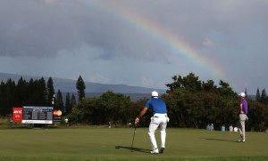 PGA golfers Jason Day and Justin Thomas putt on the third hole with a rainbow behind them during the third round of the Hyundai Tournament of Champions golf tournament at Kapalua Resort of Saturday. Photo by Brian Spurlock of USA TODAY Sports.