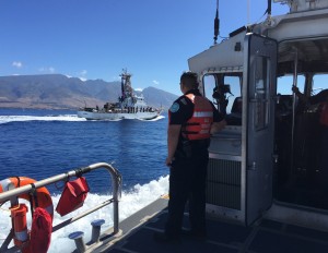 Officer Eric Vuong of Hawaii Department of Land and Natural Resources observes the USCGC Kiska (WPB 1336) and keeps a lookout for whale activity near Maui, Feb. 11, 2016. DLNR and the Coast Guard conducted safety and compliance boardings on recreational and commercial vessels to inform the public of the requirements to avoid coming too close to whales or impeding the whales’ path. (U.S. Coast Guard photo by Chief Petty Officer Sara Mooers/Released)