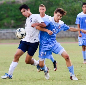 Kamehameha Maui's Jake Mateaki (5) battles for a ball with Baldwin's Hayden Hawes (24) during second-half action Friday at War Memorial Stadium. Photo by Rodney S. Yap.