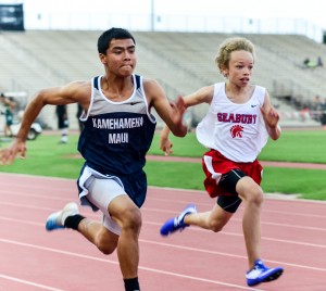 Kamehameha Maui's Tyler Baldonado-Kaleiopu and Seabury Hall's Noah Payne show their sprint technique midway through the first heat of the boys 100-meter dash. Baldonado-Kaleiopu was timed in 12.36 and Payne in 12.47. Photo by Rodney S. Yap.