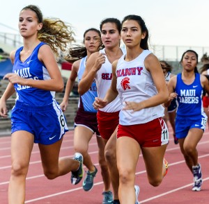 Seabury Hall's Veronica Winham and Sara Mutzenburg run to the inside of Maui High's Emily Craig (left) at the start of the girls 1500 Friday at the Yamamoto Track & Field Facility. Photo by Rodney S. Yap.