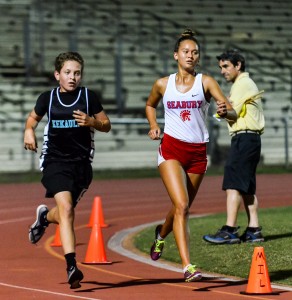 Seabury Hall's Ava Shipman won the girls 800 and 3000. King Kekaulike junior varsity winner in the 3000, Joseph Musto, ran with Shipman for a couple laps late in the race. Shipman was timed in 11:31.23 compared to Musto's 11:57.91. Photo by Rodney S. Yap.