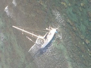 A 43-foot sailboat, Mithrandirs Dream, grounded approximately five miles east of Kaunakakai Harbor, Feb. 5, 2016. A Coast Guard MH-65 Dolphin helicopter crew from Air Station Barbers Point hoisted the two sailors aboard and safely transferred them to Kahului Airport, Maui. (U.S. Coast Guard photo courtesy of Air Station Barbers Point/Released)
