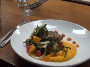 Roy's featured Localicious dish of herb-crusted fish with kabocha purée and pohole fern salad, which helps support ag education. Photo by Kiaora Bohlool.