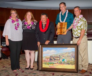 Mayor’s Office of Economic Development Directo Teena Rasmussen; Maui Chamber of Commerce President Pamela Tumpap and Mayor Alan Arakawa present the Legacy Award for Small Business Support to HC&S. (Second from right) Alexander & Baldwin President & CEO Christopher Benjamin and (far right) HC&S General Manager Rick Volner also received an original oil painting by artist Michael Clements. Maui County photo.