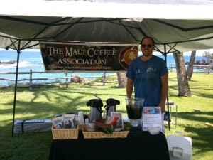 David Hanna at a booth at Montage in Kapalua, with a hand miller used to prepare coffee beans for winnowing and roasting. Courtesy of Maui Coffee Association. 