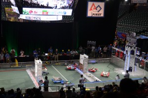 Alliances comprised of three robots each compete on the game field during qualification matches at the Hawaii FIRST Regional Competition at Stan Sheriff Center on Oahu, April 1-2, 2016.