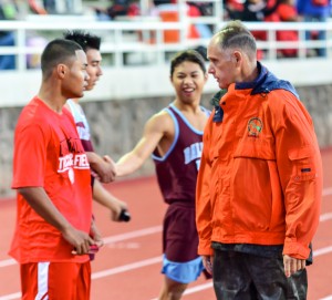 Allan Fernandez talks with a Lahainaluna athlete following the boys 400 meters at a recent track meet at Kamehameha Schools Maui. Photo by Rodney S. Yap.