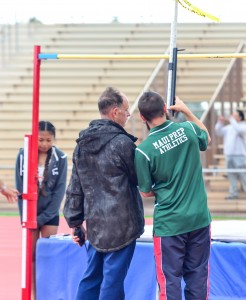 Allan Fernandez oversees the measuring of the high jump bar with a Maui Prep Academy coach. Photo by Rodney S. Yap.