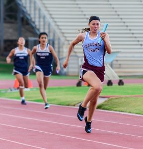 Baldwin's Kaitlin Smith anchors the Lady Bears' 4x100 relay to victory Friday. Photo by Rodney S. Yap.