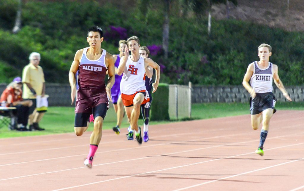 Baldwin's Bailey Kaopuiki blows the competition away in his heat of the 200-meter dash Friday. The Baldwin sprinter was timed in 21.92 seconds to lead all qualifiers. Photo by Rodney S. Yap.