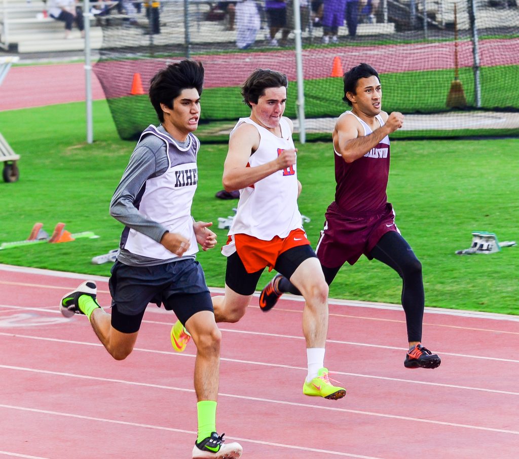 Kihei Charter's Justice Crozier held this lead to win the 400-meter dash Saturday against Seabury Hall's Cole Christie and Baldwin's Kainalu Marquez. Photo by Rodney S. Yap.