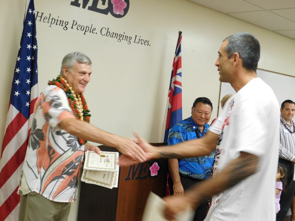 Retiring director Craig Swift congratulates BDC graduate as he hots is final graduation before he retires. Photo courtesy Maui Economic Opportunity.