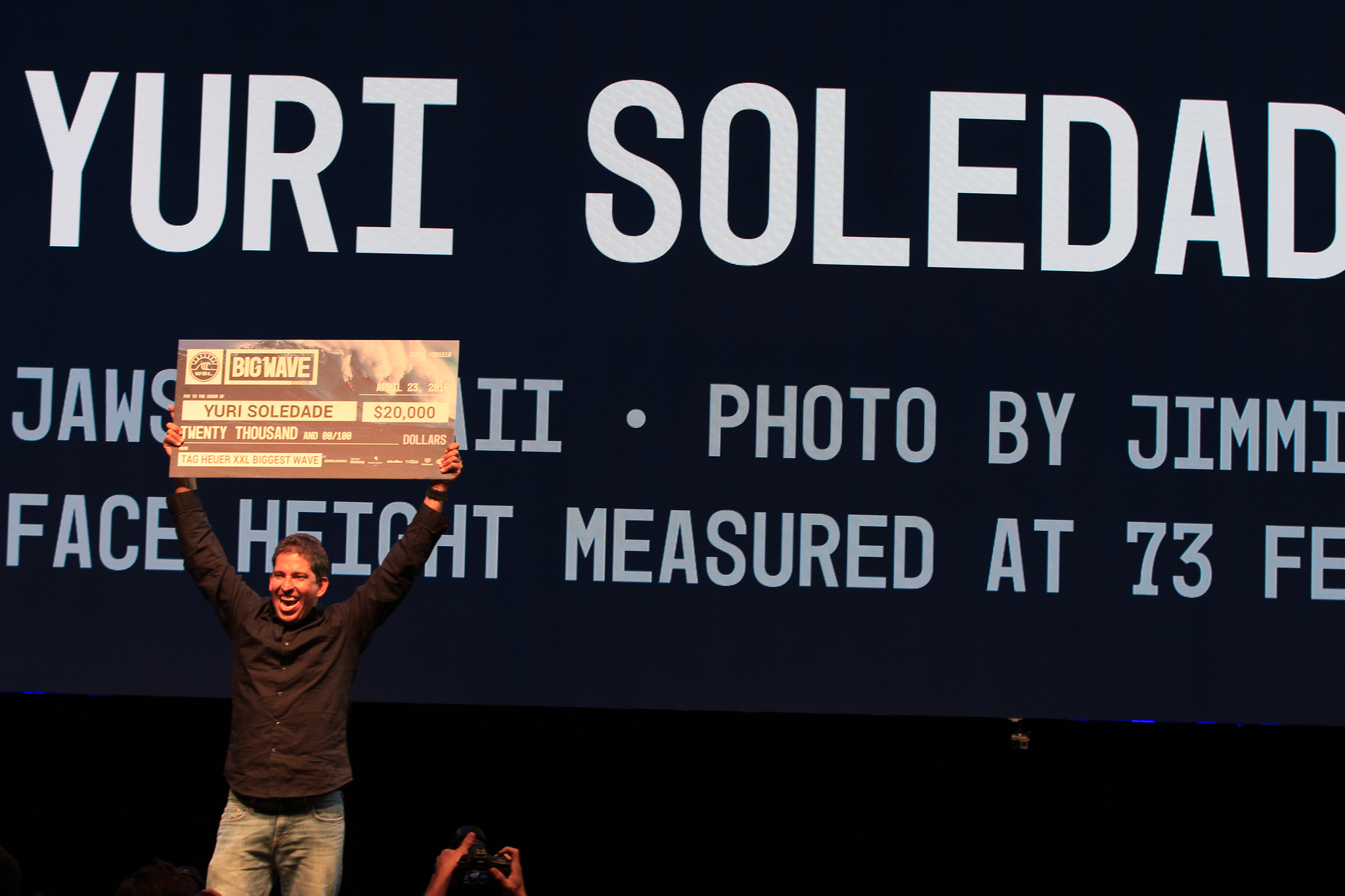 Yuri Soledad claims his prize at the XXL Big Wave Awards Photo: WSL
