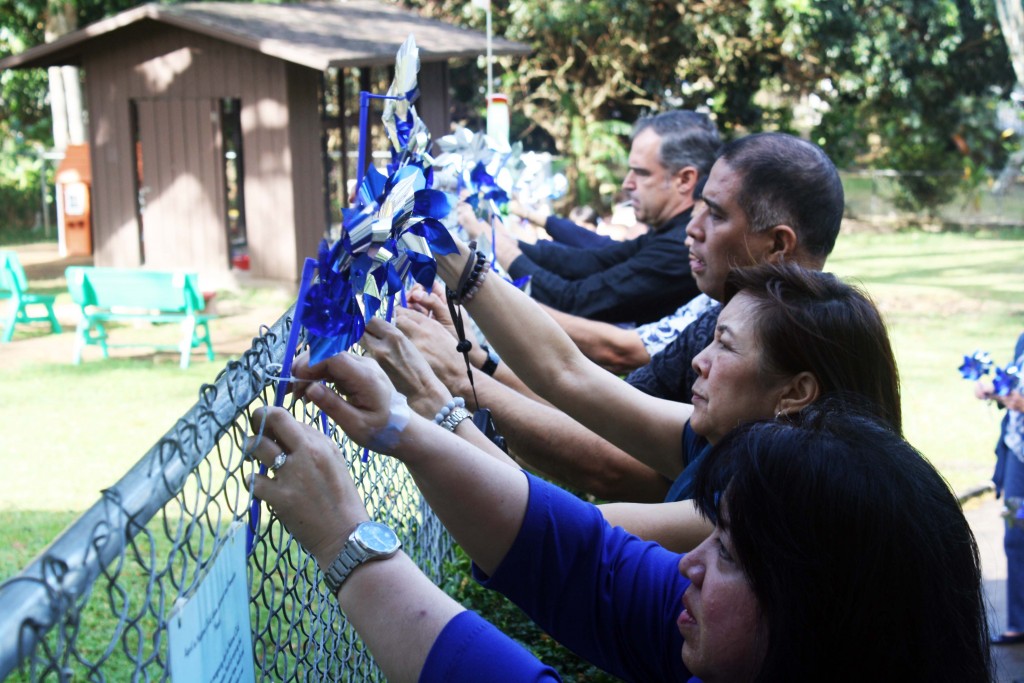 Children’s Justice Center (CJC) staff and partner agencies are hanging pinwheels in front of the CJC-Oahu on April 8, 2016 as part of Child Abuse Awareness and Prevention Month.
