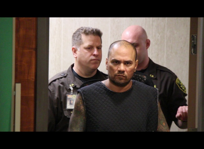 Defendant Stephen Schmidt was escorted into Wailuku District Court dressed in a dark colored padded over garment with shackles to his hands and feet.