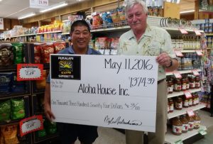 Pukalani Superette Owner Myles Nakashima presents a check to Aloha House CEO Jud Cunningham.