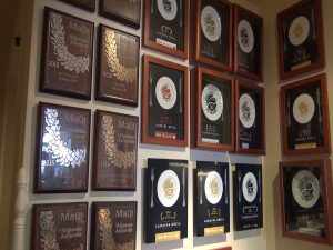 Wall of awards at Lāhainā Grill. Photo by Kiaora Bohlool.