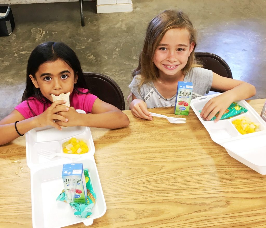 Second graders Muzik Kekiwi Vares and Tayon Spencer eat breakfast at Kahului Community Center (KCC) PALS. Photo credit: County of Maui, Dept. of Parks and Recreation (Ryan Min).