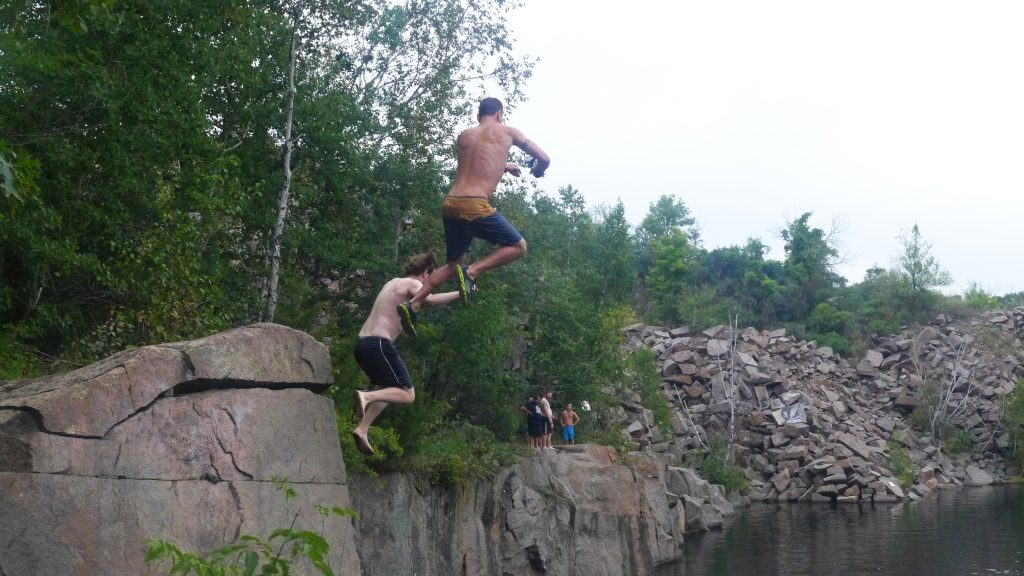 Swimmers take a flying leap from the red granite cliffs of Minnesota's Quarry Park. Photo credit: Travel Channel.