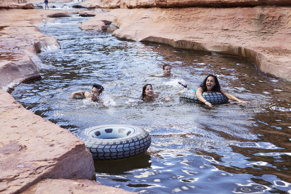 Swimmers float along Arizona's Slide Rock, a red-walled wonder with a slippery natural waterslide. Photo credit: Travel Channel.