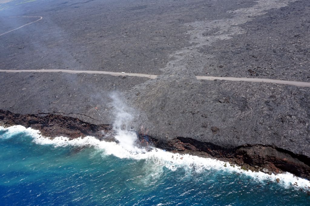  Just over two months since the start of the 61g flow, it reached the ocean on July 26 at 1:15 am HST. The narrow ocean entry was creating a small plume of gas and steam during today's overflight as the lava came into contact with the ocean. Photo credit: USGS/Hawaiian Volcano Observatory.