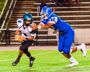 Maui High defensive end Jamie Fisher is about to sack King Kekaulike quarterback Earl Naki-Vea, during first-half action Friday at War Memorial Stadium. Photo by Rodney S. Yap.