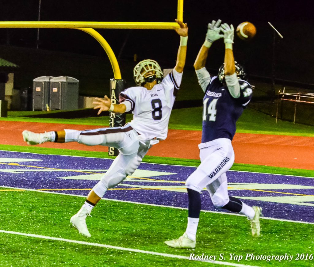 Baldwin's Jansen Roldan breaks up this pass intended for Kamehameha Maui's Nathan Facuri. Photo by Rodney S. Yap.