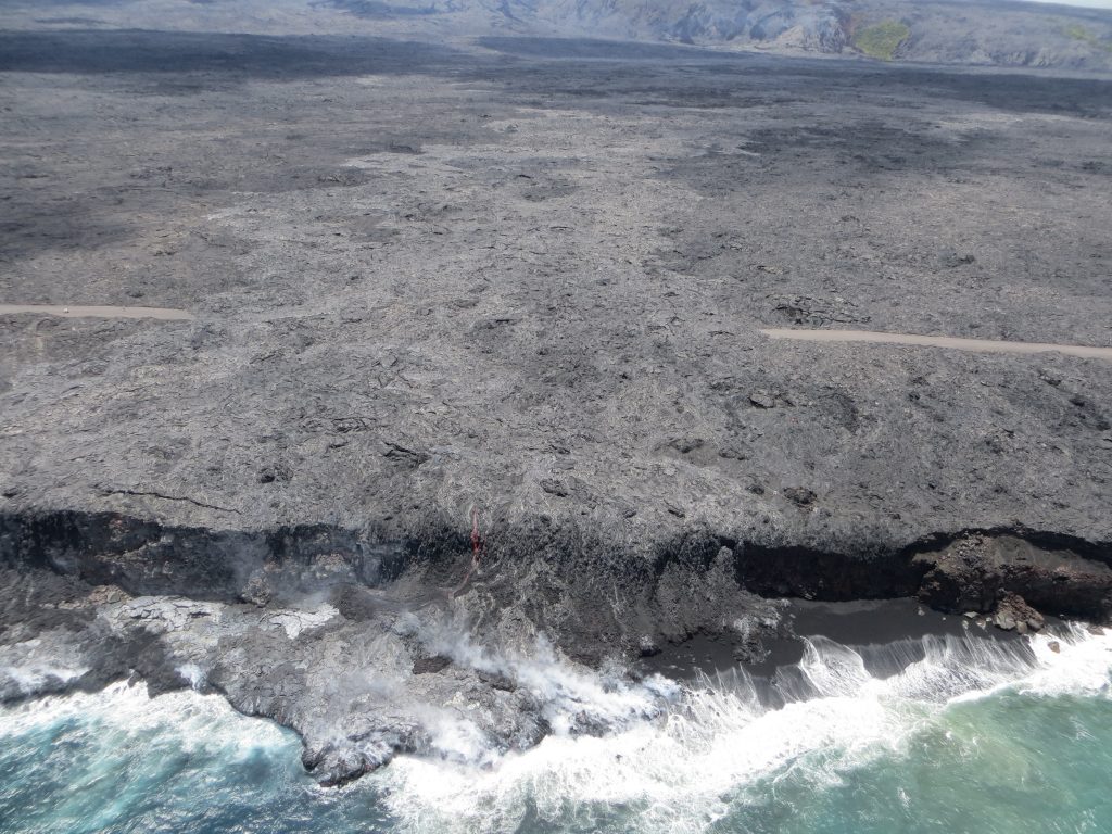 During today's overflight of Kīlauea Volcano's "61g" lava flow, the ocean entry appeared less robust, with only one small flow of active lava streaming over the sea cliff. The second, smaller ocean entry point, west of this main entry (noted in our July 29 photo), was not active at the time of the overflight. (8.2.16) Photo credit: HVO/USGS.