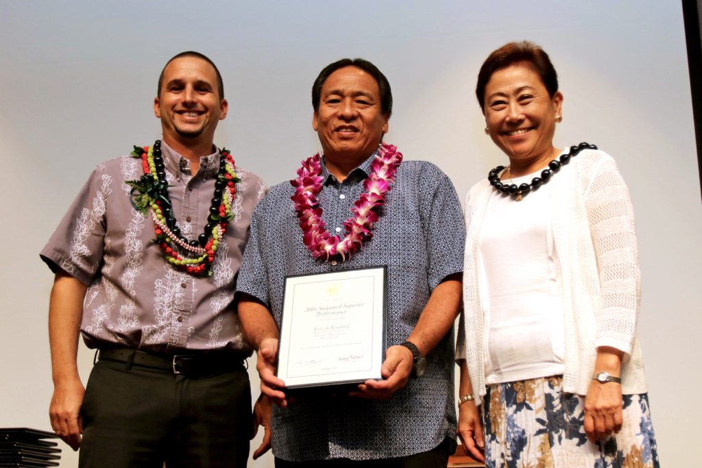 Edgar Yoshida, Baldwin High School, Maui District (middle) wins the DOE's Sustained Superior Performance Award.