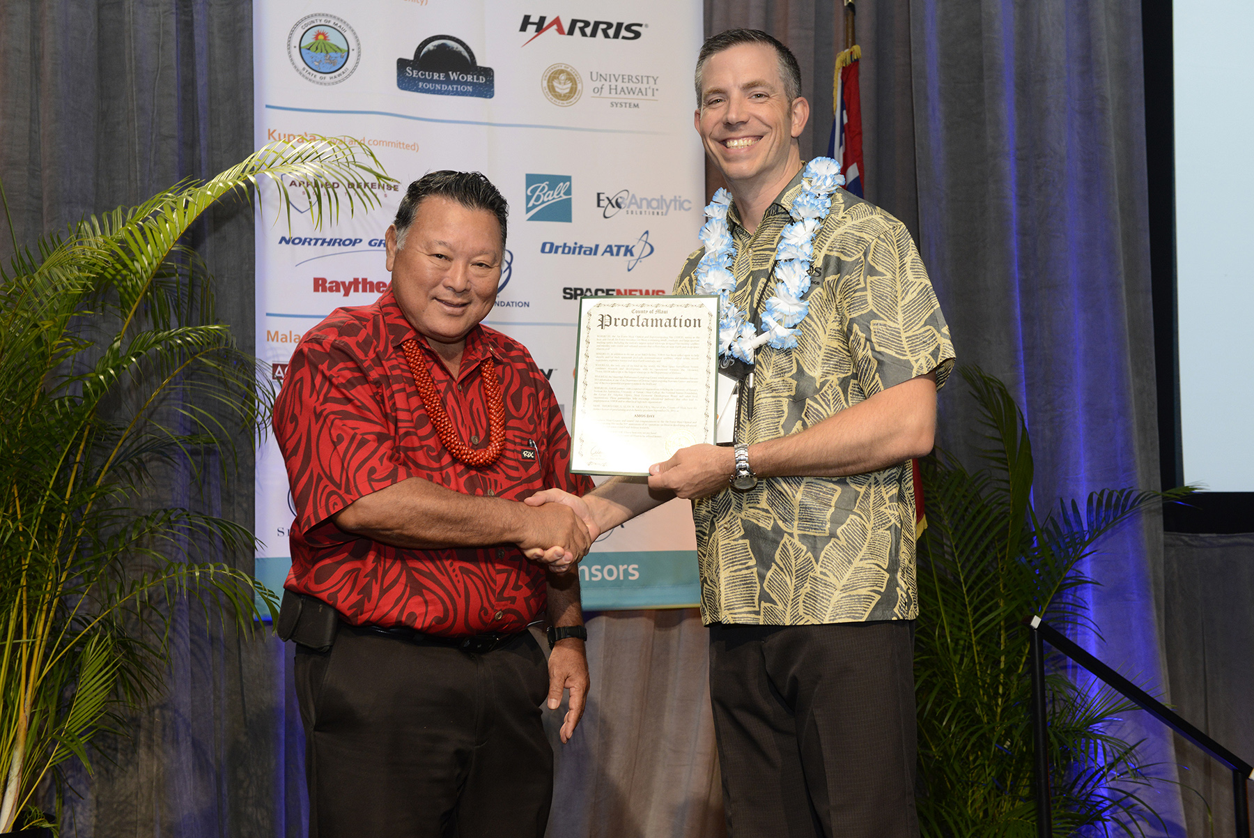 Mayor Alan Arakawa and Lieutenant Colonel Andrew Emery commander of Air Force Research Laboratory’s Detachment 15 in Kihei, with a proclamation naming September 21 as AMOS Day.