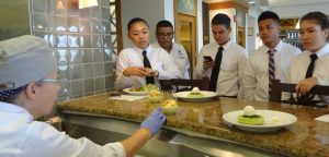 Chef Teresa Shurilla explaining dessert to student servers at Leis Family Class Act Restaurant on the first day of service this season. Courtesy photo.