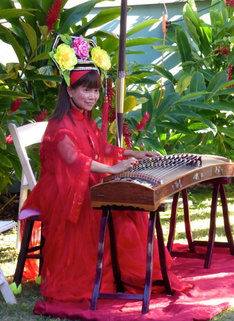 Toi performing on the gu zheng harp, a traditional Chinese instrument, at the Moon Festival in Lahaina. Photo courtesy: Lahaina Restoration Foundation.