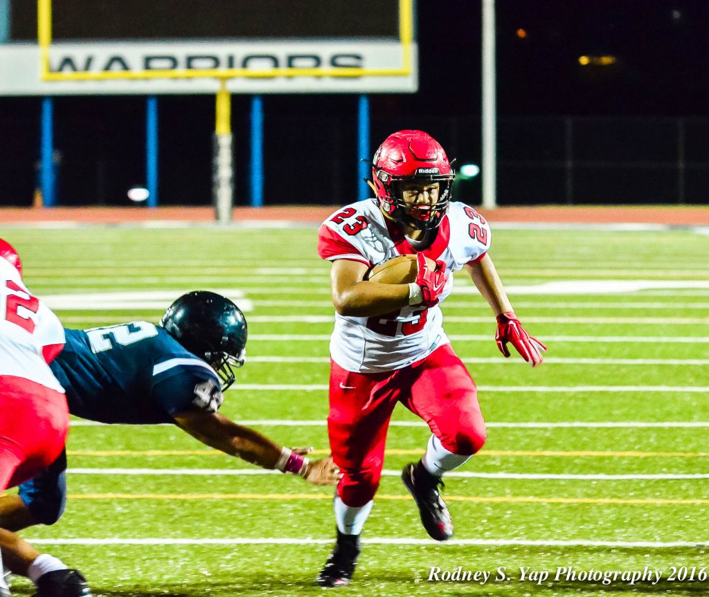 Lahainaluna's Dean Miyamoto helps set up the Lunas' second touchdown of the night. Photo by Rodney S. Yap.