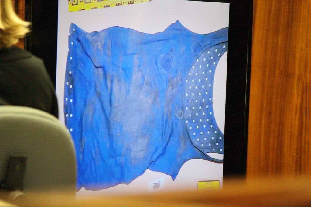 Anthony Earls, evidence specialist with the Maui Police Department describes staining on a blue tank top found at Nuaʻailua Bay. Photo by Wendy Osher.