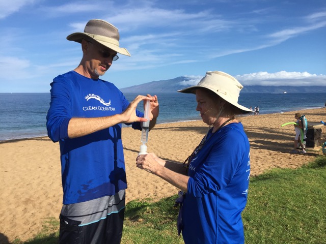 Citizen-science volunteers Ty Freiberg (left) and Marie Schroeder (right) collect water quality samples on Maui as part of the island's newly launched Hui O Ka Wai Ola water quality monitoring program.